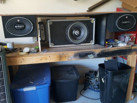 1994 Ford Bronco - A car stereo system is displayed on a workbench with various tools and storage bins.