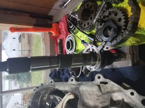 1996 Ford Bronco - Various transmission components and tools are laid out on a workbench, suggesting a repair or rebuild process.