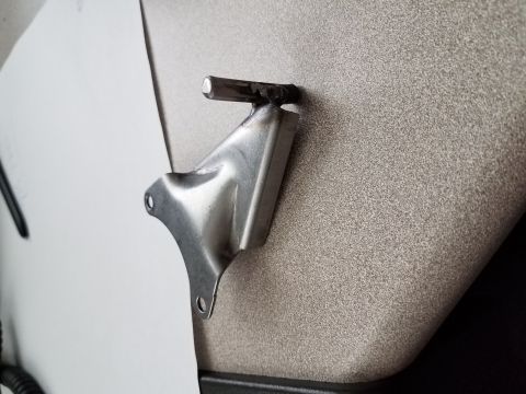 1996 Ford Bronco - Close-up of a metal bracket with a welded pin, likely a vehicle part.