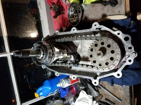 1996 Ford Bronco - The internal components of a vehicle's transfer case are laid out, showing gears and a chain drive system.
