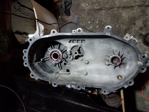1996 Ford Bronco - A disassembled transmission casing is shown with internal components and bearings.