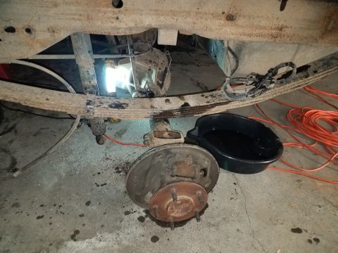 1996 Ford Bronco - The rear brake assembly and suspension components are visible, suggesting maintenance or repair work is underway.