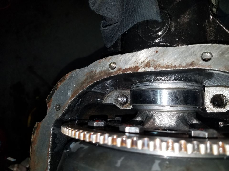 Close-up of vehicle differential housing with gears and bearing.