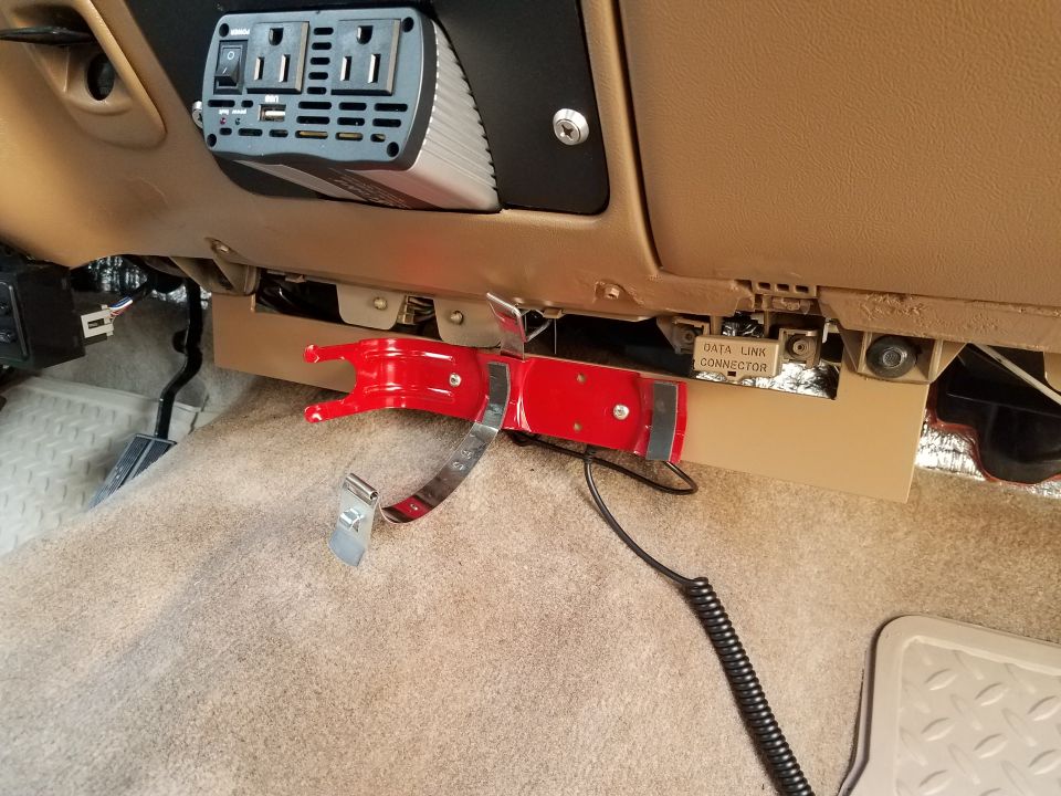 Interior vehicle shot showing power inverter and fire extinguisher mount.