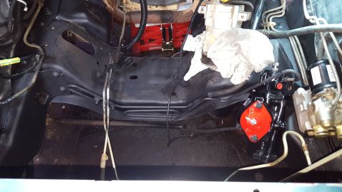 1996 Ford Bronco - A close-up view of the engine bay of a 1996 Ford Bronco shows a newly installed black and red steering gear box, hydraulic lines, and other…
