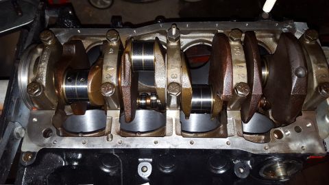 1996 Ford Bronco - This is a close-up view of the crankshaft and connecting rod assembly within an engine block. The crankshaft has multiple journals, and the…