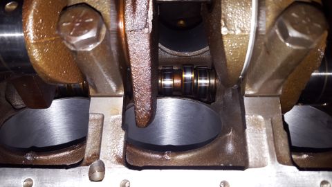 1996 Ford Bronco - This is a close-up view of the internal components of an engine, likely a crankshaft and connecting rod assembly. The metallic parts show s…