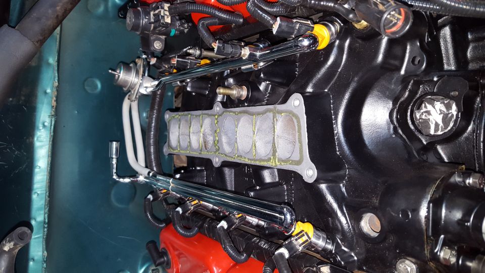 Engine intake manifold with fuel rails and injectors