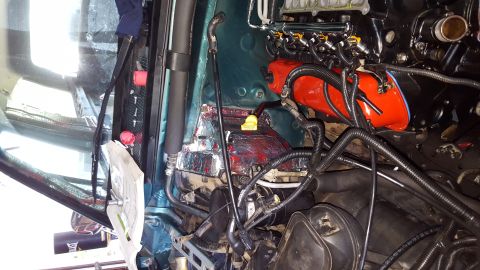1996 Ford Bronco - The engine bay of a vehicle is shown, with various components including the engine block, fuel injectors, and wiring harnesses. Sound-dampe…