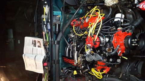 1996 Ford Bronco - A close-up view of a modified engine bay, featuring a black engine with red MSD ignition components and yellow spark plug wires. An open se…