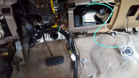 1996 Ford Bronco - The interior of a vehicle's dashboard is shown with exposed wiring, pedals, and a control module. A new push-button start ignition is visib…