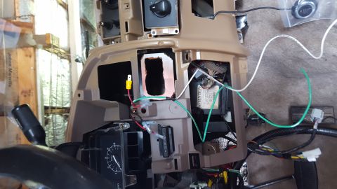 1996 Ford Bronco - Interior view of a vehicle's dashboard area with wiring and components exposed. A push-to-start button and various wires are visible, sugge…