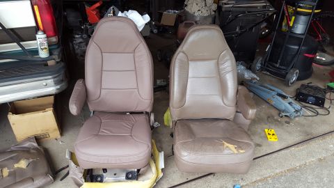 1996 Ford Bronco - Two tan leather car seats are shown, one appearing newer and in better condition than the other which shows significant wear and tear. The…