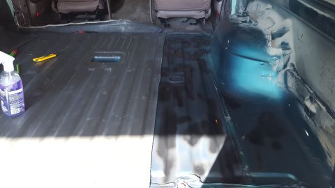 1996 Ford Bronco - The interior of a vehicle is shown with the floor partially covered in what appears to be sound deadening material. A spray bottle and a ut…