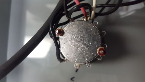 1996 Ford Bronco - A close-up view of a Grayhill rotary switch with numbered positions from 1 to 12, mounted inside a metal enclosure. Wires are connected to…
