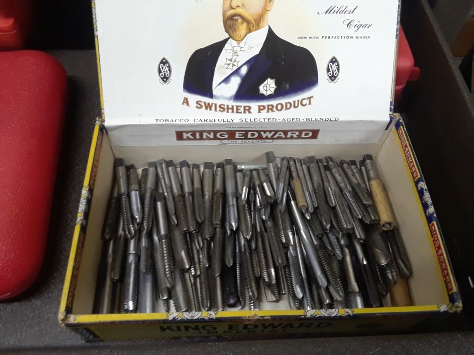 King Edward cigar box filled with metal taps
