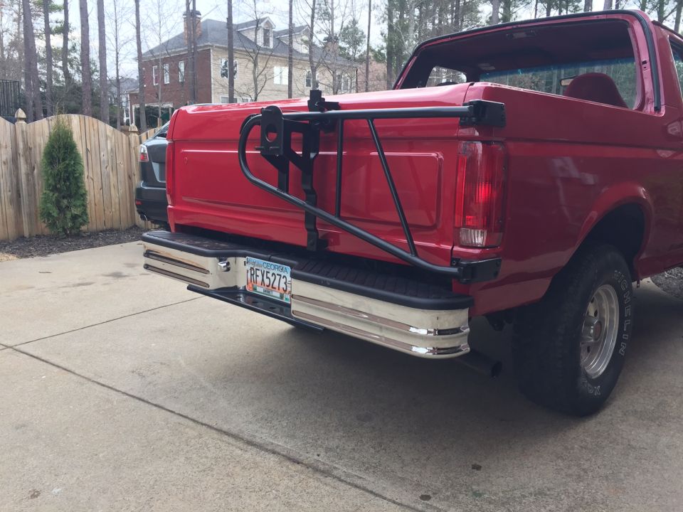 Red Ford Bronco rear view with spare tire carrier and Georgia license plate RFX5273.