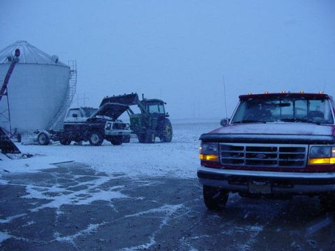 1992 Ford Bronco - A red 1992 Ford F-250 is parked in a snowy field next to a silo and tractor.