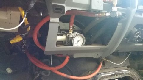 1995 Ford Bronco - This image shows a custom air system installed in the dashboard area of a 1995 Ford Bronco. Visible components include red air hoses, a pre…