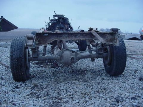 1992 Ford Bronco - The rear chassis and drivetrain of a vehicle are shown, with the engine block visible above the frame.