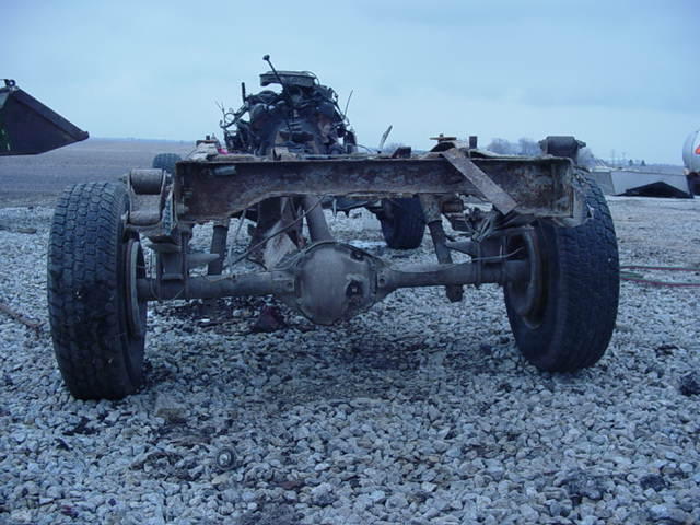 Vehicle chassis and drivetrain with rear axle and tires visible
