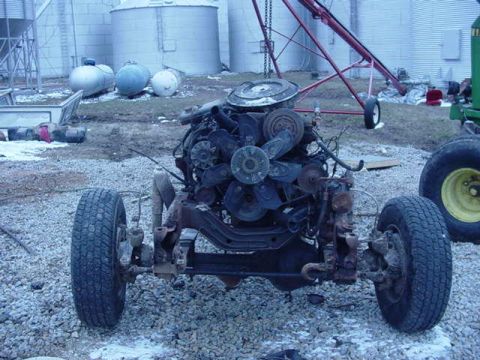 1992 Ford Bronco - The engine and front chassis of a vehicle are shown, with one wheel in the foreground.