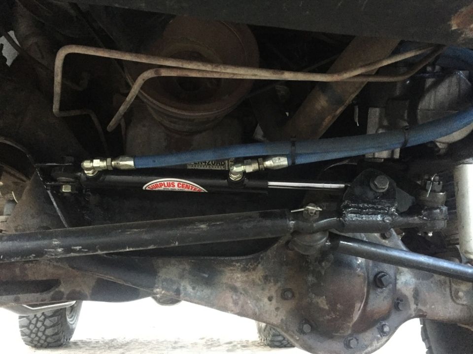 1984 Ford Bronco hydraulic steering assist cylinder on front axle.