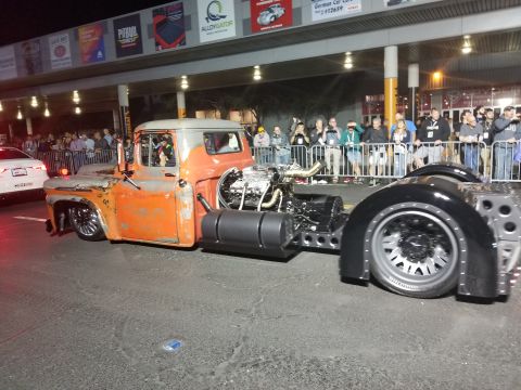 1969 Pontiac Firebird - A heavily modified truck with a prominent engine and custom chassis is displayed, its unique build.