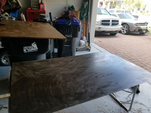 1994 Ford Bronco - Two vehicles are parked inside a garage, with one white SUV and a silver coupe visible.