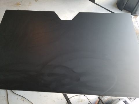 1994 Ford Bronco - A black panel with a distinctive V-shaped cutout is shown, possibly a car part.