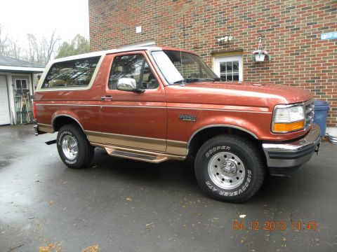 1988 Ford Bronco - This 1992 Ford Bronco is shown in a three-quarter front view, parked outside a brick building.