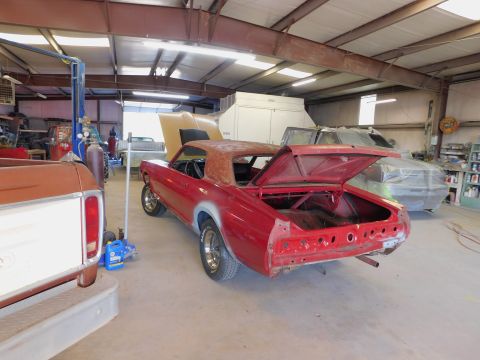 1968 Mercury Cougar - A red 1968 Mercury Cougar is seen from the rear in a garage, with its trunk open and undergoing restoration.