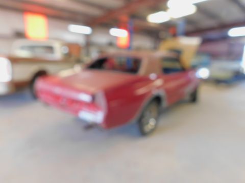 1968 Mercury Cougar - Rear view of a red 1968 Mercury Cougar coupe in a workshop setting.