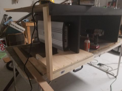 1994 Ford Bronco - Car amplifier installed in a custom wooden enclosure, with tools present.
