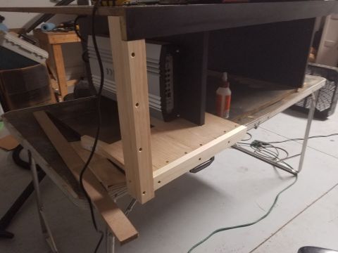 1994 Ford Bronco - A car amplifier is installed in a custom wooden enclosure, likely for a car stereo system.