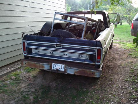 1967 Ford F-250 - This 1973 Ford F-series pickup truck is loaded with a metal rack and other items in its bed.
