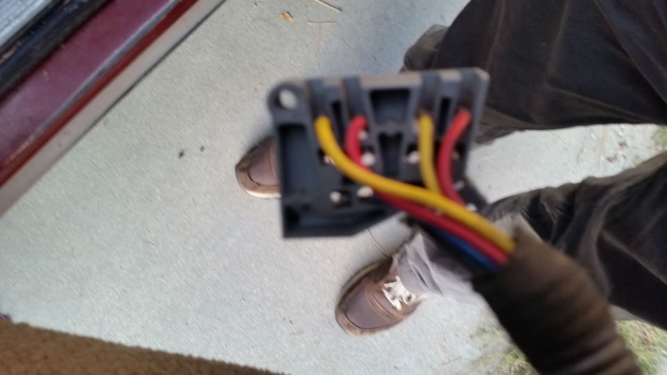 Gray electrical connector with red, yellow, and blue wires.