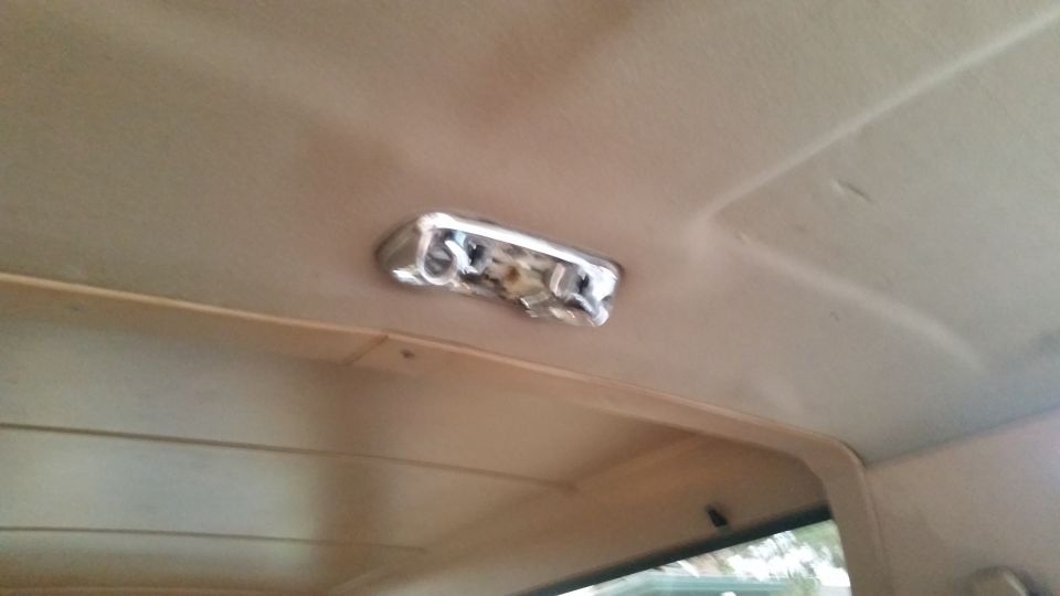 Interior headliner with chrome dome light fixture