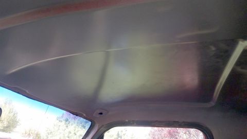 1985 Ford Bronco - The interior of a vehicle's headliner is shown from a low angle, looking upwards. The headliner appears to be bare metal, possibly after a…