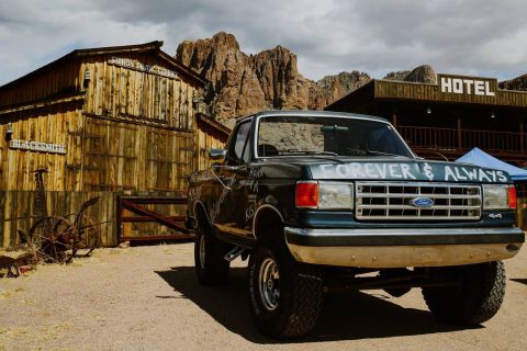 1988 Ford Bronco - A lifted Ford truck sits in front of a rustic hotel and blacksmith shop in a desert town.