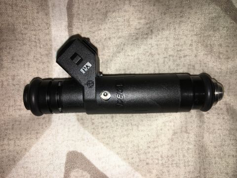 1996 Ford Bronco - A single black fuel injector is shown against a textured background.