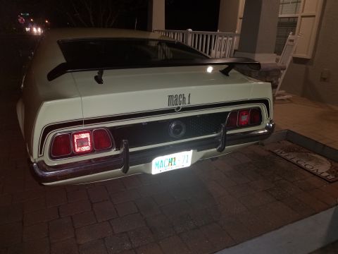 1971 Ford Mustang - The rear of a 1971 Ford Mustang Mach 1 is shown, its distinctive taillights and spoiler.