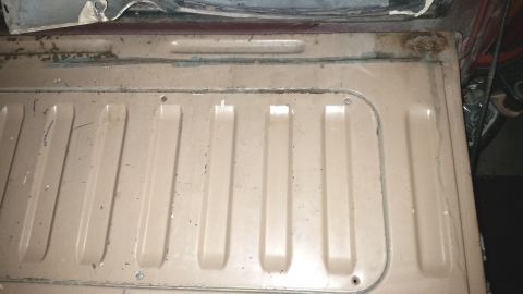 1985 Ford Bronco - Close-up of the ribbed metal floor in the rear cargo area of a vehicle, showing signs of wear and rust.