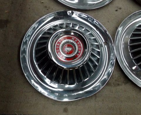 1964 Mercury Monterey - A close-up of a vintage Mercury hubcap, the brand's emblem and text around the center.