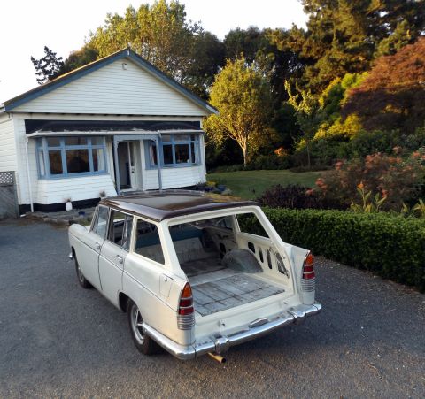 1962 MG B - The interior of this station wagon is stripped down, showing the bare metal and wooden floor panels.