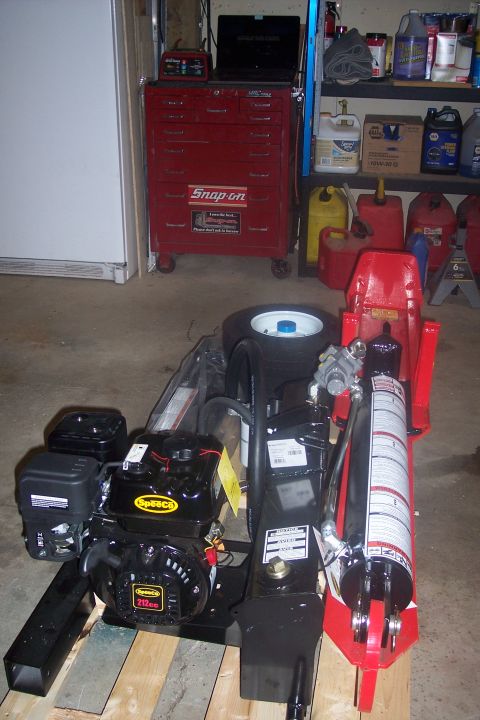 1995 Ford Bronco - A Speeco engine and a red hydraulic jack are shown in a garage setting.