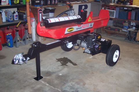 1995 Ford Bronco - A red log splitter with a SpeedCo SplitMaster label is shown in a garage setting.