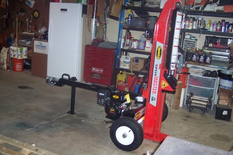 1995 Ford Bronco - A red log splitter is shown in a garage setting with various tools and shelves in the background.