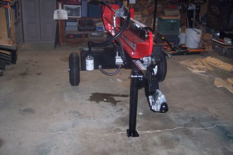 1995 Ford Bronco - Log splitter with black frame and wheels is parked in a garage setting.