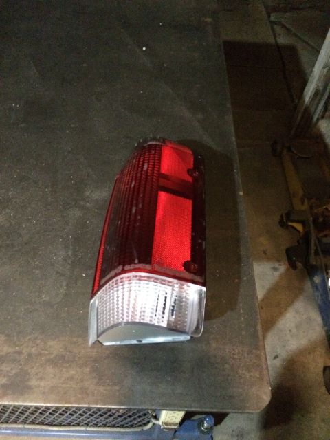 1989 Ford Bronco - Tail light assembly, likely for a truck or SUV, shown on a workbench.